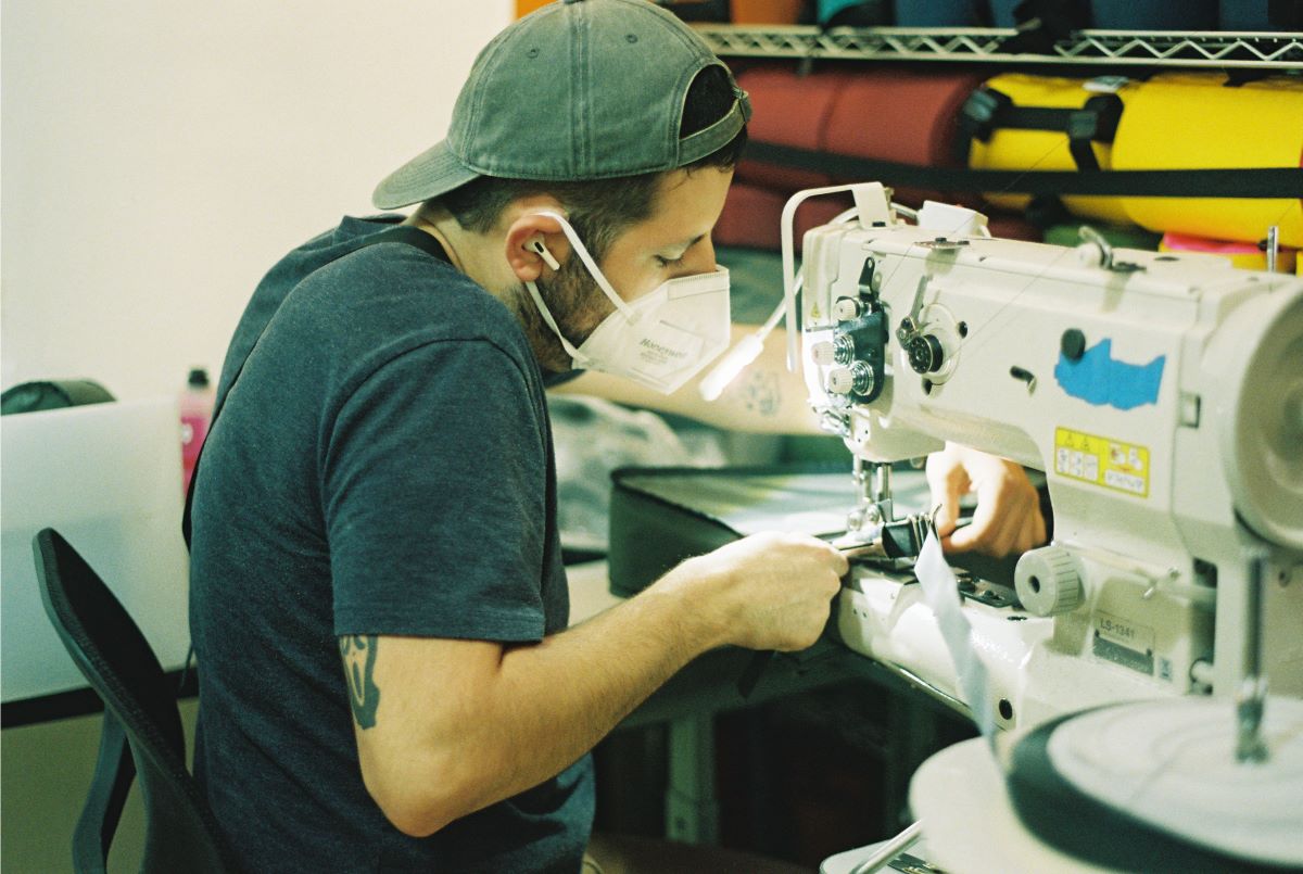 Daniel sewing in the Road Runner Bags production facility